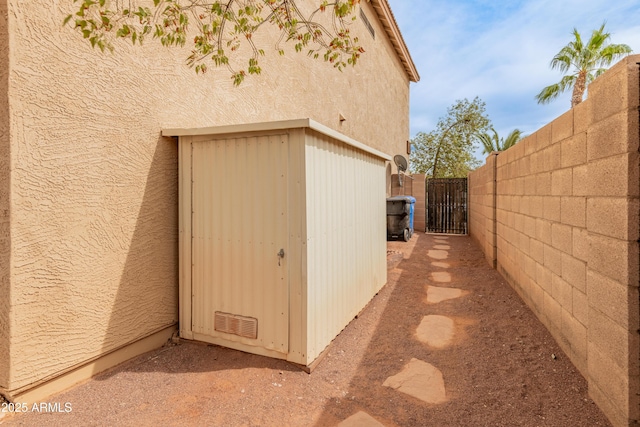 view of outdoor structure featuring a gate and fence