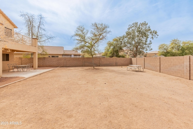 view of yard featuring a patio area and a fenced backyard