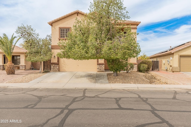 view of front of property featuring a tile roof, stucco siding, and concrete driveway