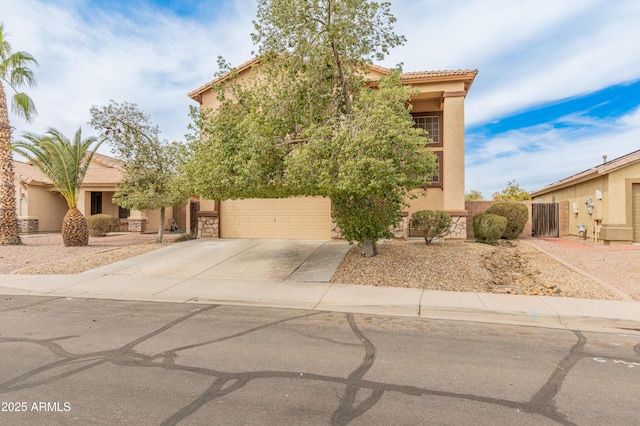 view of front of property featuring concrete driveway, a tiled roof, a garage, and stucco siding