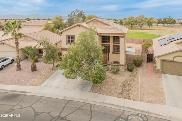 view of front of property with a gate, stucco siding, driveway, and a tile roof