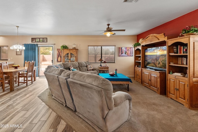 living room featuring light wood-type flooring, visible vents, pool table, and ceiling fan with notable chandelier