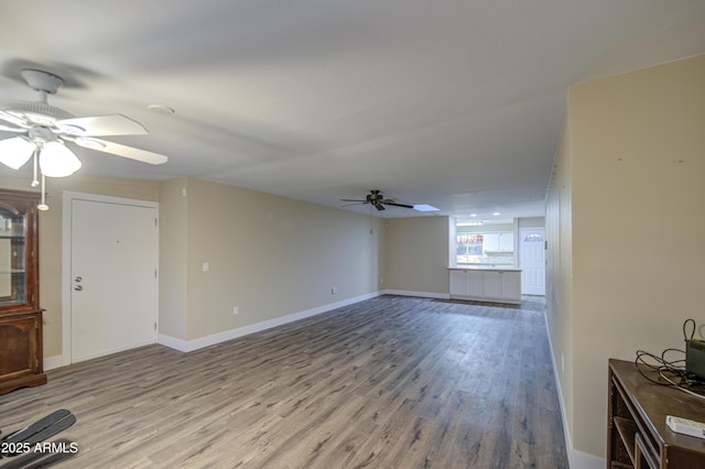 10620 W Clair Dr, Sun City, AZ 85351 - unfurnished living room featuring ceiling fan, wood finished floors, and baseboards