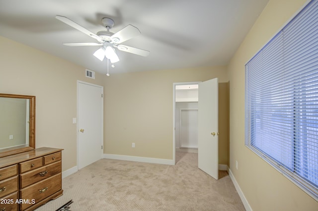 10620 W Clair Dr, Sun City, AZ 85351 - unfurnished bedroom featuring light colored carpet, ceiling fan, and baseboards
