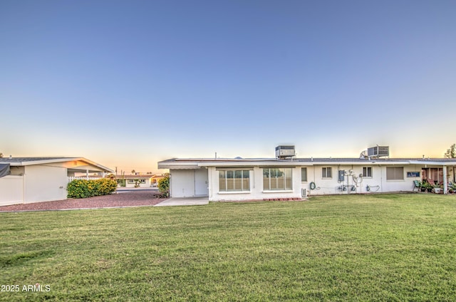 10620 W Clair Dr, Sun City, AZ 85351 - back of property with a lawn and cooling unit