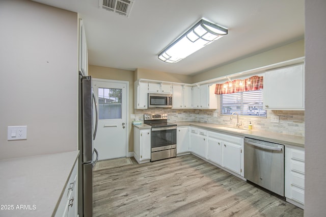 10620 W Clair Dr, Sun City, AZ 85351 - kitchen with appliances with stainless steel finishes, a sink, tasteful backsplash, and healthy amount of natural light