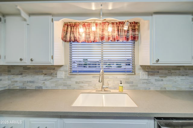 10620 W Clair Dr, Sun City, AZ 85351 - kitchen featuring a sink, decorative backsplash, and white cabinetry