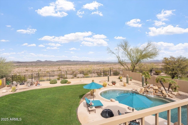 view of swimming pool featuring a fenced backyard, a mountain view, a fenced in pool, and a yard