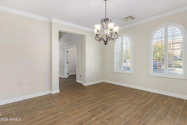 unfurnished room featuring a chandelier, dark hardwood / wood-style floors, and ornamental molding