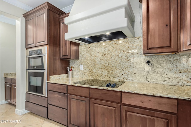 kitchen featuring premium range hood, black electric stovetop, decorative backsplash, light tile patterned flooring, and stainless steel double oven