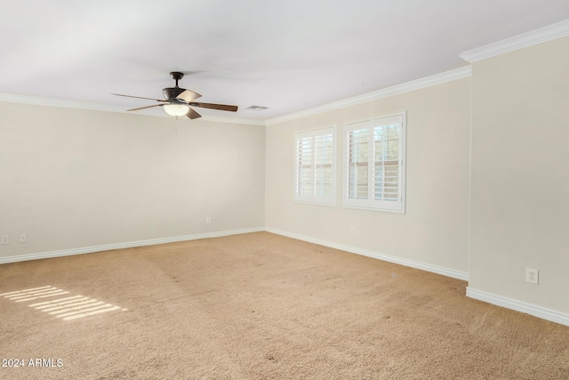 carpeted empty room with ceiling fan and ornamental molding