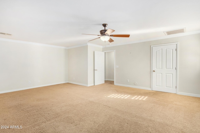 carpeted spare room featuring ceiling fan and ornamental molding