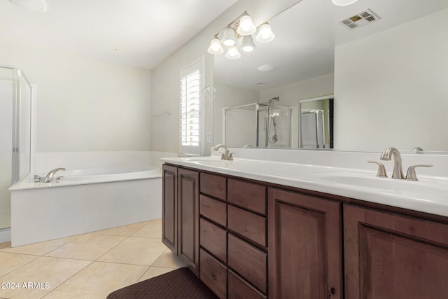 bathroom with tile patterned flooring, vanity, and separate shower and tub