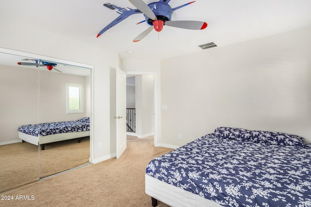 bedroom with ceiling fan, a closet, and carpet floors