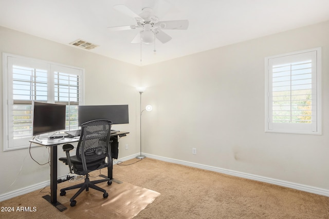 office space with carpet, ceiling fan, and a healthy amount of sunlight