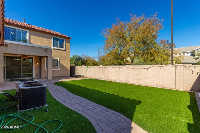 view of yard featuring a patio area and central AC