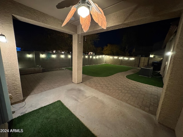 patio at twilight featuring ceiling fan