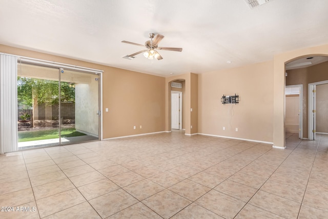 tiled spare room with ceiling fan