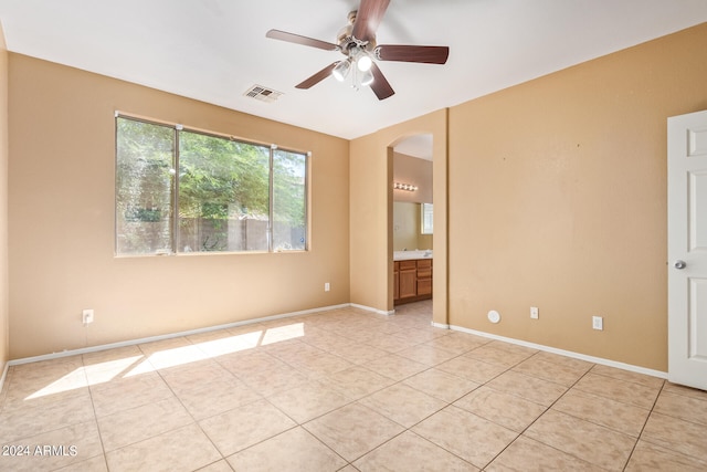 unfurnished room with ceiling fan and light tile patterned floors