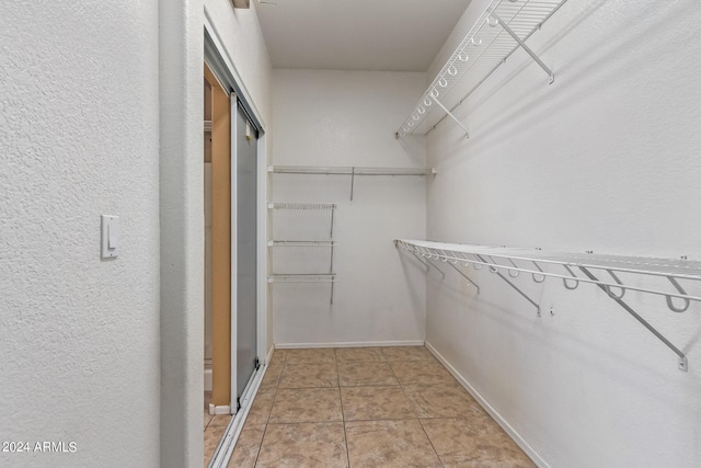 spacious closet featuring light tile patterned floors