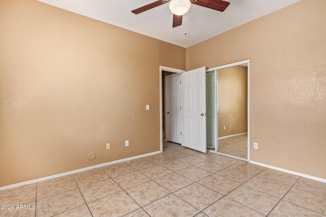 spare room with light tile patterned floors and ceiling fan