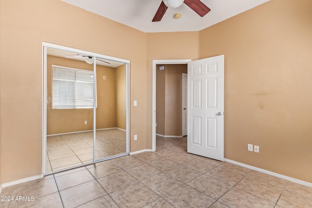 unfurnished bedroom featuring light tile patterned floors, ceiling fan, and a closet