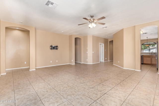 tiled empty room with ceiling fan