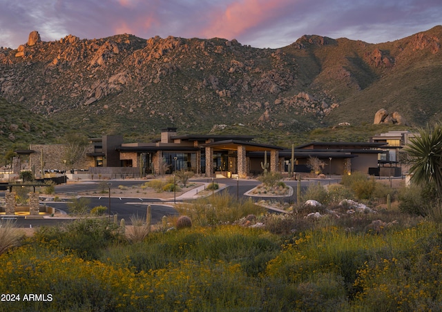 back house at dusk with a mountain view