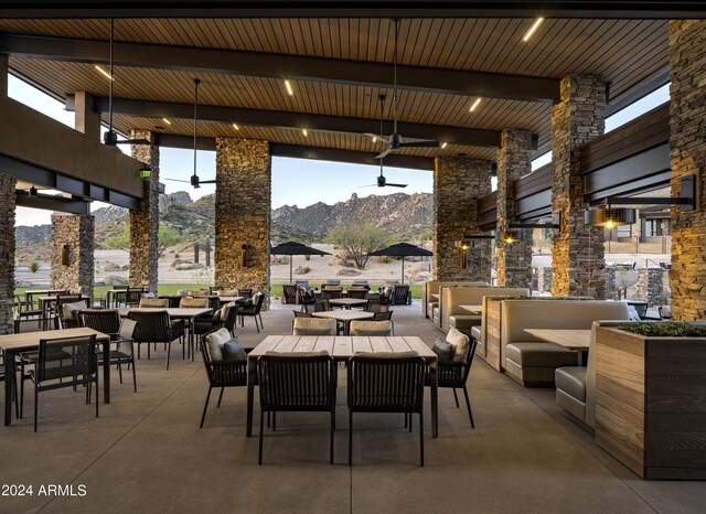 view of patio / terrace featuring ceiling fan, a mountain view, and an outdoor living space