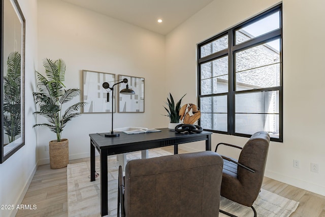 office space featuring a wealth of natural light and light hardwood / wood-style flooring