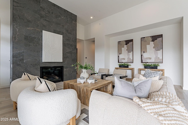 living room with a fireplace and light hardwood / wood-style flooring