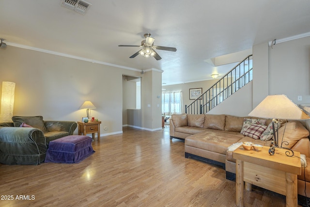 living room with crown molding, hardwood / wood-style floors, and ceiling fan