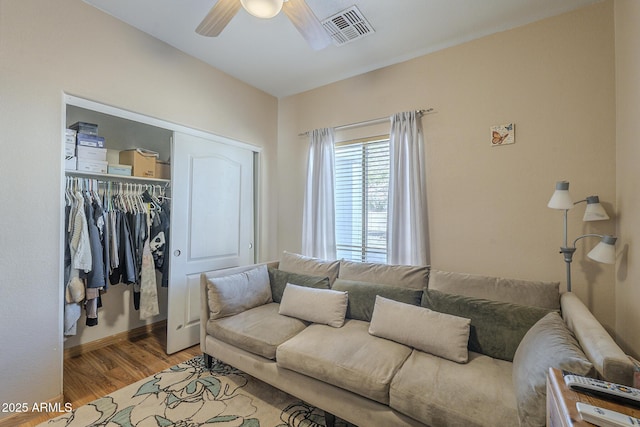 living room with ceiling fan and light hardwood / wood-style flooring