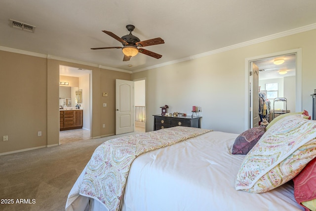 carpeted bedroom with ornamental molding, ceiling fan, and ensuite bathroom