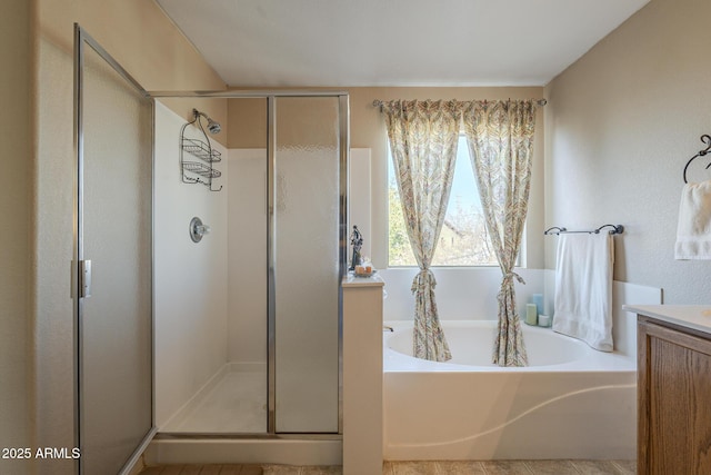 bathroom with vanity and independent shower and bath