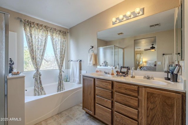 bathroom featuring vanity and shower with separate bathtub