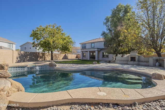 view of swimming pool with a patio, an in ground hot tub, and exterior fireplace