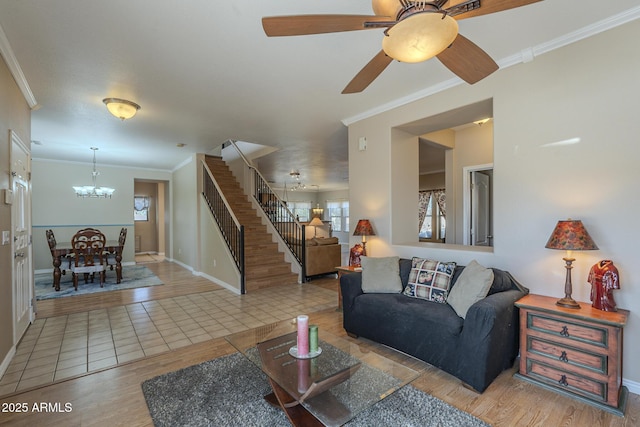 living room with crown molding, ceiling fan with notable chandelier, and hardwood / wood-style floors