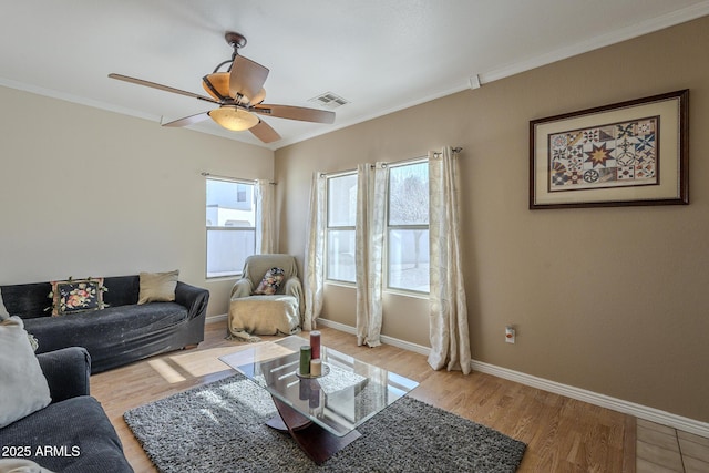 living room featuring crown molding, ceiling fan, and light wood-type flooring