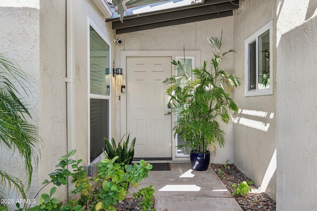 entrance to property with stucco siding