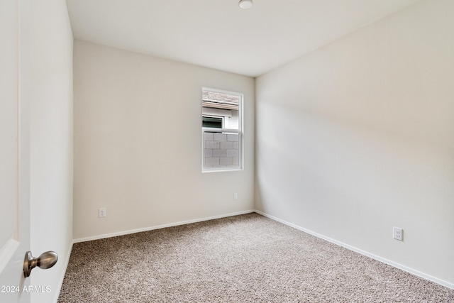 unfurnished room with baseboards and carpet flooring