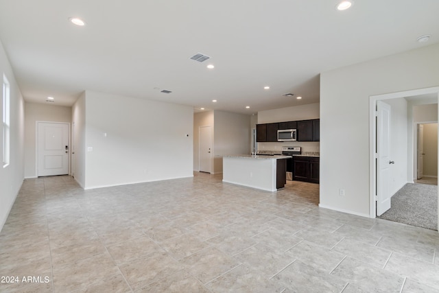 unfurnished living room featuring baseboards, visible vents, and recessed lighting