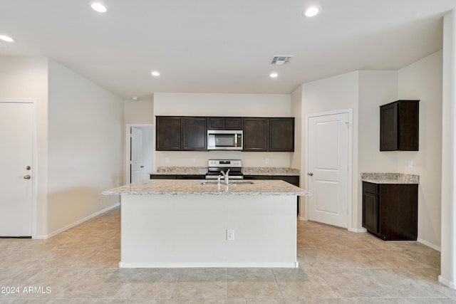 kitchen with appliances with stainless steel finishes, a kitchen island with sink, visible vents, and recessed lighting