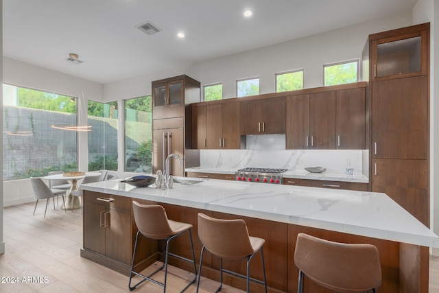 kitchen featuring a wealth of natural light, a spacious island, and light hardwood / wood-style flooring