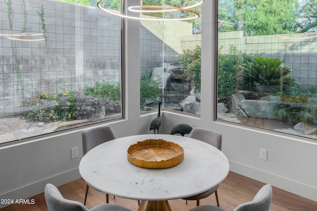 dining area with hardwood / wood-style floors and a chandelier