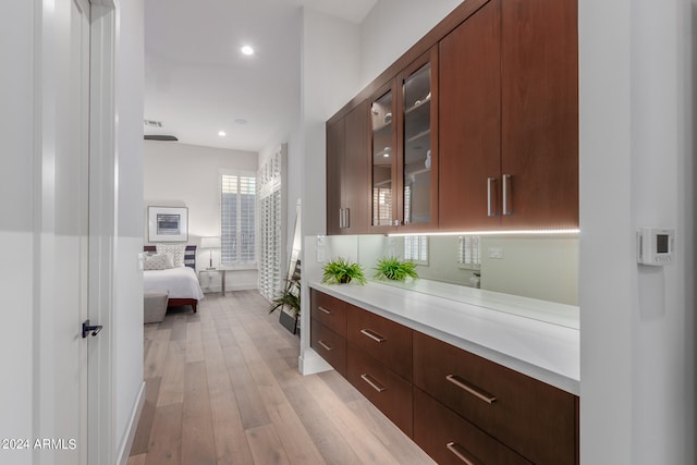 corridor with light hardwood / wood-style floors