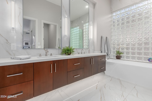 bathroom with vanity and a washtub