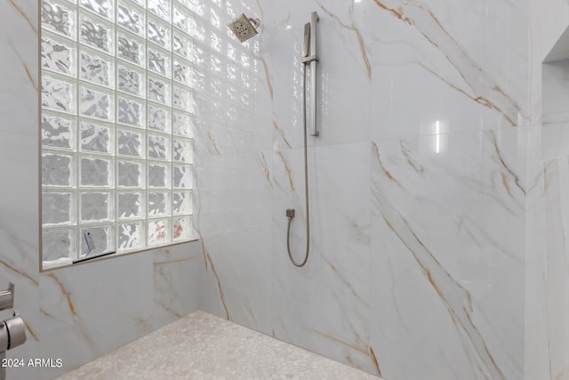 bathroom with a tile shower