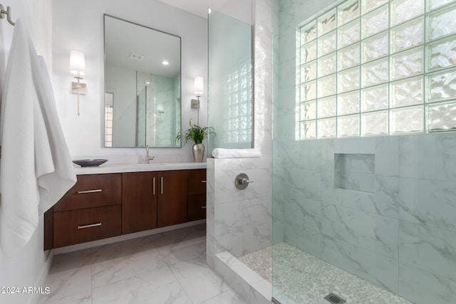 bathroom featuring vanity and tiled shower