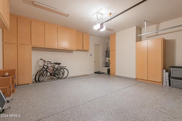 garage with gas water heater and a garage door opener